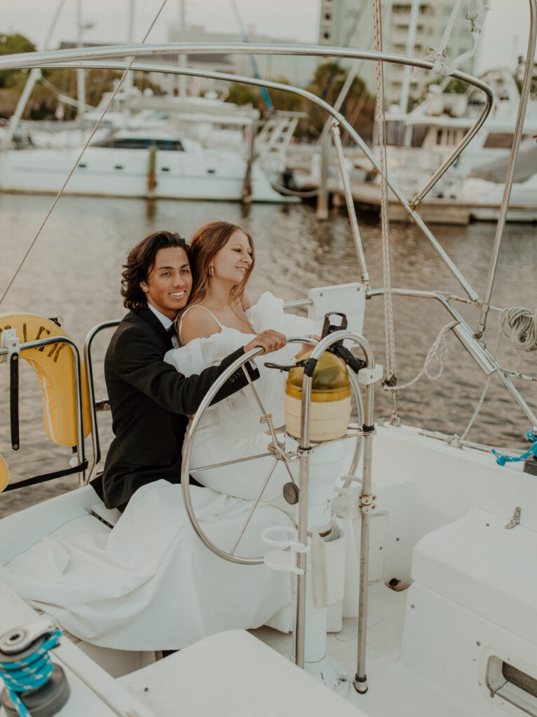 Driving a sailboat in a wedding dress
